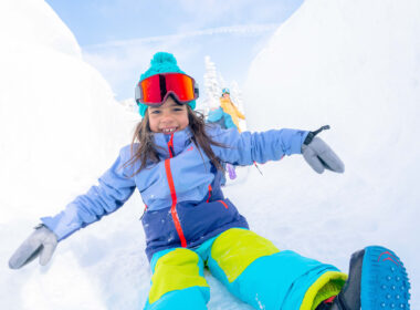 Child sliding down ice slide Kindred Resort Keystone