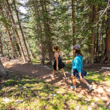Two women hiking in the mountains Kindred Resort Keystone